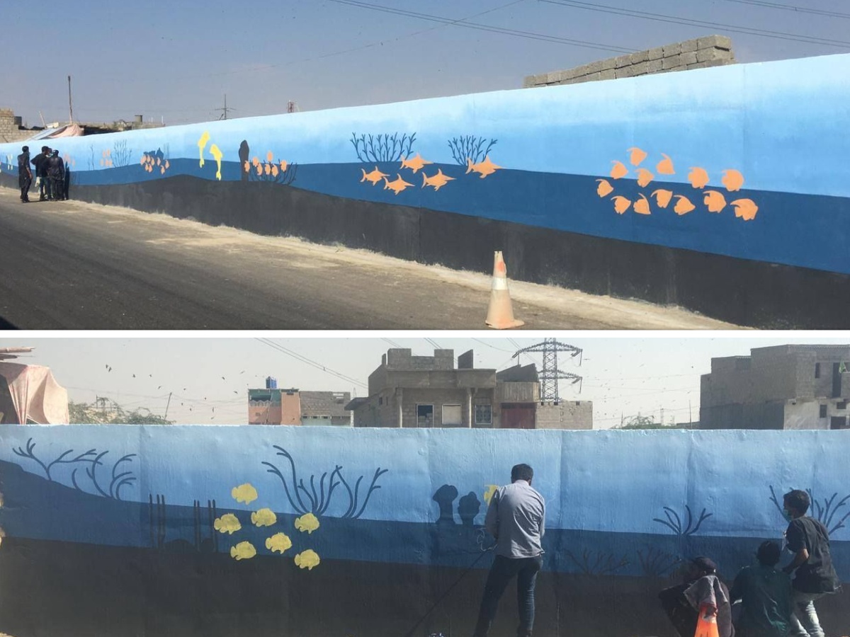 Artists painting walls in Korangi Area